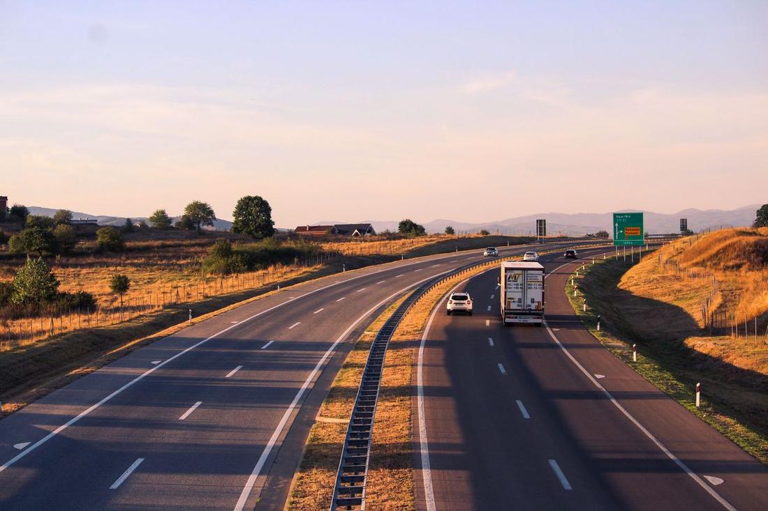 Vrachtwagen op een Nederlandse snelweg bij zonsondergang